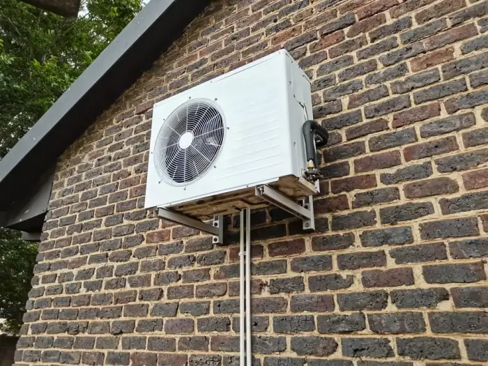 Outdoor condenser mounted on a face-brick wall by SJS Cooling