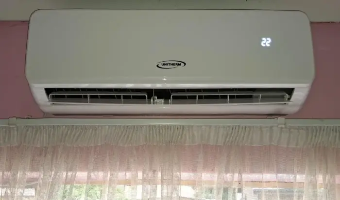 Indoor split unit installed above a window by SJS Cooling