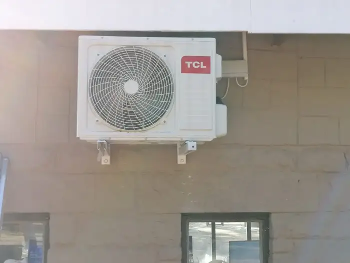 TCL outdoor unit installed on a building wall by SJS Cooling